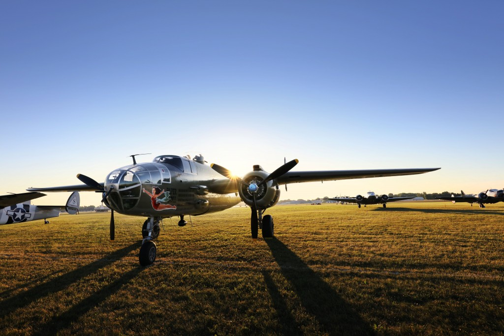 The sun is rising behing a restored B-25 Mitchell World War II bomber. (Photo: GE Reports)