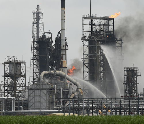 Smoke billows from Motiva's Convent Refinery as emergency officials respond to a fire near Convent, La., Thursday, Aug. 11, 2016. Firefighters contained the blaze that broke out Thursday at the refinery along the Mississippi River between New Orleans and Baton Rouge. (Bill Feih/The Advocate via AP)