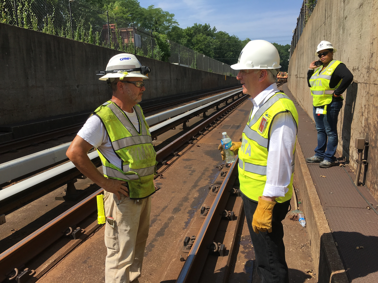 In this photo taken July 25, 2016, Metro General Manager Paul Wiedefeld, right, chats with an employee during a tour of track work being done on Metro's orange line in northern Virginia. Wiedefeld ordered the track work, which requires trains in both directions to share a single line, as part of his effort to make the deteriorating system safer and more reliable. (AP Photo/Ben Nuckols)