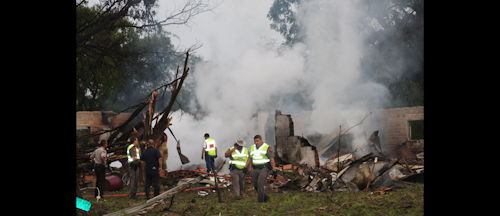 In this Monday, Aug. 22, 2016, photo, provided by The Eagle Pass News Gram, authorities work the scene after a truck carrying Takata inflators and a volatile chemical exploded in the Texas border town of Quemado, killing a woman and injuring four others. Takata Corp. said it sent people to the site and is helping authorities investigate the crash. (Ruben Carrillo Mazuka/The Eagle Pass News Gram via AP)