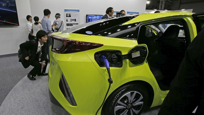 Toyota Motor Corp's Prius PHV is displayed at the Smart Community Japan exhibition in Tokyo, Japan. Toyota's much ballyhooed plug-in hybrid Prius Prime is being pushed back by several months, with the new sales date set for late this year or early next year. (AP Photo/Shuji Kajiyama,File)