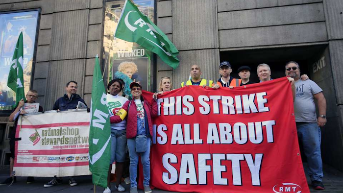Rail workers form a picket line opposite Victoria Station during a strike in London, Monday, Aug. 8, 2016. (Jonathan Brady/PA via AP)