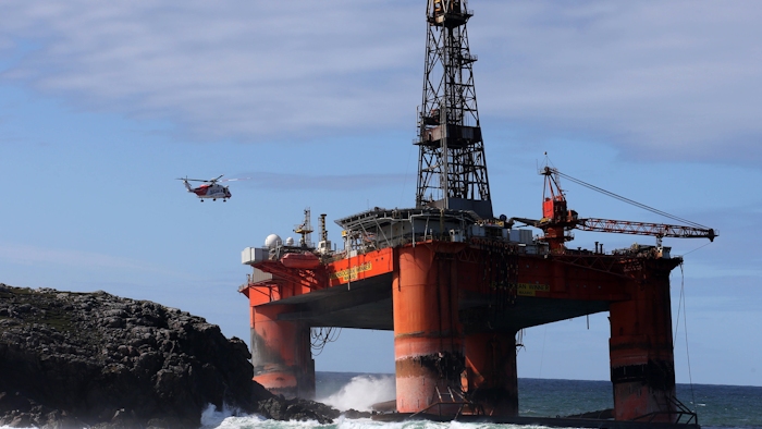 The oil rig, carrying 280 tonnes of diesel, broke free of its tug and ran aground on the remote Scottish island where it is being monitored by a counter-pollution team. (Andrew Milligan / PA via AP)