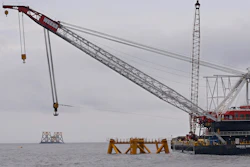 A construction crane works over a foundation installed for a wind turbine by Deepwater Wind off the coast of Block Island, R.I. Deepwater Wind anticipates opening the first U.S. offshore wind farm there in the fall of 2016. (AP Photo/Stephan Savoia, File)