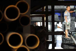 Laborers work at a steel market in Yichang in central China's Hubei province. (Chinatopix via AP)