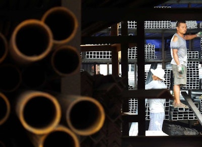 Laborers work at a steel market in Yichang in central China's Hubei province. (Chinatopix via AP)