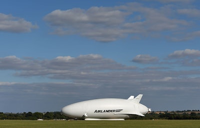 The makers of a blimp-shaped, helium-filled airship billed as the world's biggest aircraft postponed its maiden flight at the last minute on Sunday. (Joe Giddens/PA via AP)