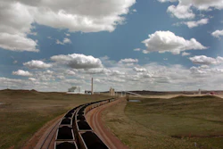 A pair of coal trains idle on the tracks near Dry Fork Station, a coal-fired power plant being built by the Basin Electric Power Cooperative near Gillette, Wyo. (AP Photo/Matthew Brown, File)
