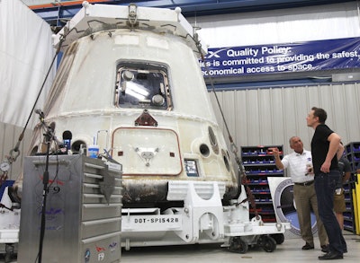 NASA Administrator Charles Bolden, second right, and SpaceX CEO Elon Musk, right, look at the SpaceX Dragon spacecraft at the SpaceX Rocket Development Facility in McGregor, Texas. (Duane A. Laverty/Waco Tribune-Herald via AP)