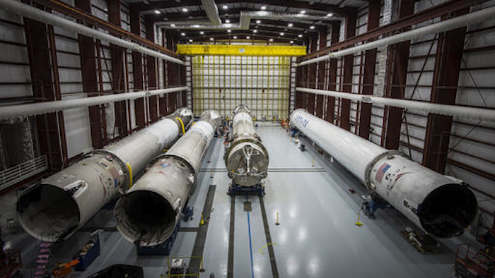This June 6, 2016 photo made available by SpaceX shows recovered Falcon rocket boosters in a hangar at the Kennedy Space Center on Merritt Island, Fla. (SpaceX via AP)