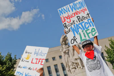 Tusweca Mendoza, 10, of Arlington, Va., originally from Pine Ridge, S.D., holds up a sign outside U.S. District Court in Washington, Tuesday, Sept. 6, 2016, as members of the Standing Rock Sioux Tribe have asked a federal judge to temporarily stop work on parts of the Dakota Access Pipeline to prevent the destruction of sacred and culturally significant sites near Lake Oahe. (AP Photo/Pablo Martinez Monsivais)