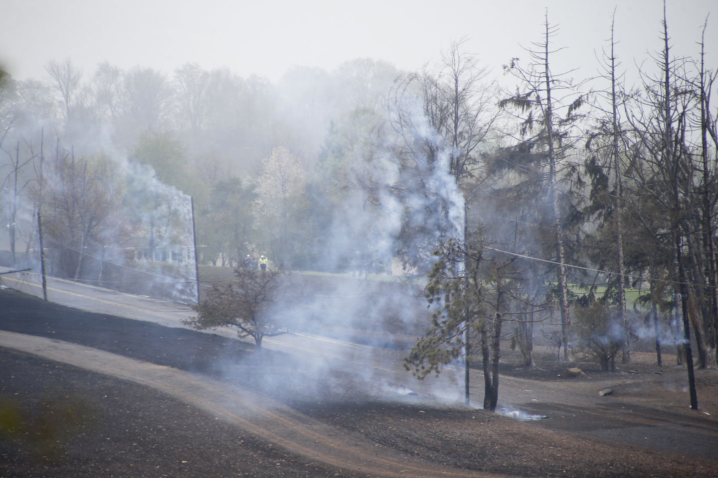 In this April 29, 2016, file photo, smoke pours off charred trees where a natural gas explosion at a pipeline damaged houses in Salem Township, Pa. Faster-than-expected corrosion caused a Pennsylvania natural gas pipeline blast that scorched 40 acres and badly burned a man whose home was destroyed, according to findings of Houston-based Spectra Energy Corp. presented Tuesday, Sept. 13, 2016, at a public meeting in Westmoreland County's Salem Township, about 30 miles east of Pittsburgh. (AP Photo/Keith Srakocic, File)