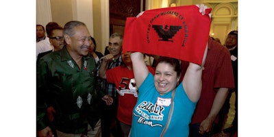 FILE -- In this Aug. 29, 2016 file photo Maria Ceja, right, joined other farm workers in celebrating outside the Assembly Chambers after lawmakers approved a measure requiring farmworkers to receive overtime pay after working eight hours, at the Capitol, in Sacramento, Calif. Calif. Gov. Jerry Brown, announced Monday, Sept. 12, 2016, that he signed the bill, AB1066, by Assemblywoman Lorena Gonzalez, D-San Diego. At left is Arturo Rodriguez, president of the United Farm Workers. (AP Photo/Rich Pedroncelli, File)