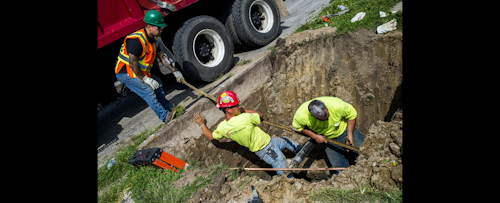 Crews break ground and work to remove and replace lead-tainted pipes from three homes during first day of the second phase under Mayor Karen Weaver's Fast Start program Wednesday, Aug. 31, 2016, in Flint, Mich. The program was launched in March and has replaced infrastructure at over two dozen Flint homes. There are an estimated 250 homes pegged to have service lines replaced during the program's second phase. (Jake May/The Flint Journal-MLive.com via AP)