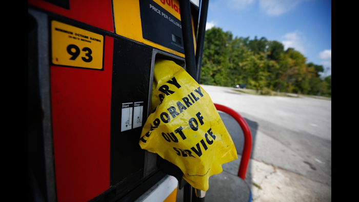 A yellow bag reads 'sorry temporarily out of service' informing customers of a gas outage at a station in Alabaster, Ala., on Monday, Sept. 19, 2016, Alabama Gov. Robert Bentley issued a state of emergency after a pipeline spill near Helena, Ala. Gas prices spiked and drivers found 'out of service' bags covering pumps as the gas shortage in the South rolled into the work week, raising fears that the disruptions could become more widespread. (AP Photo/Brynn Anderson)