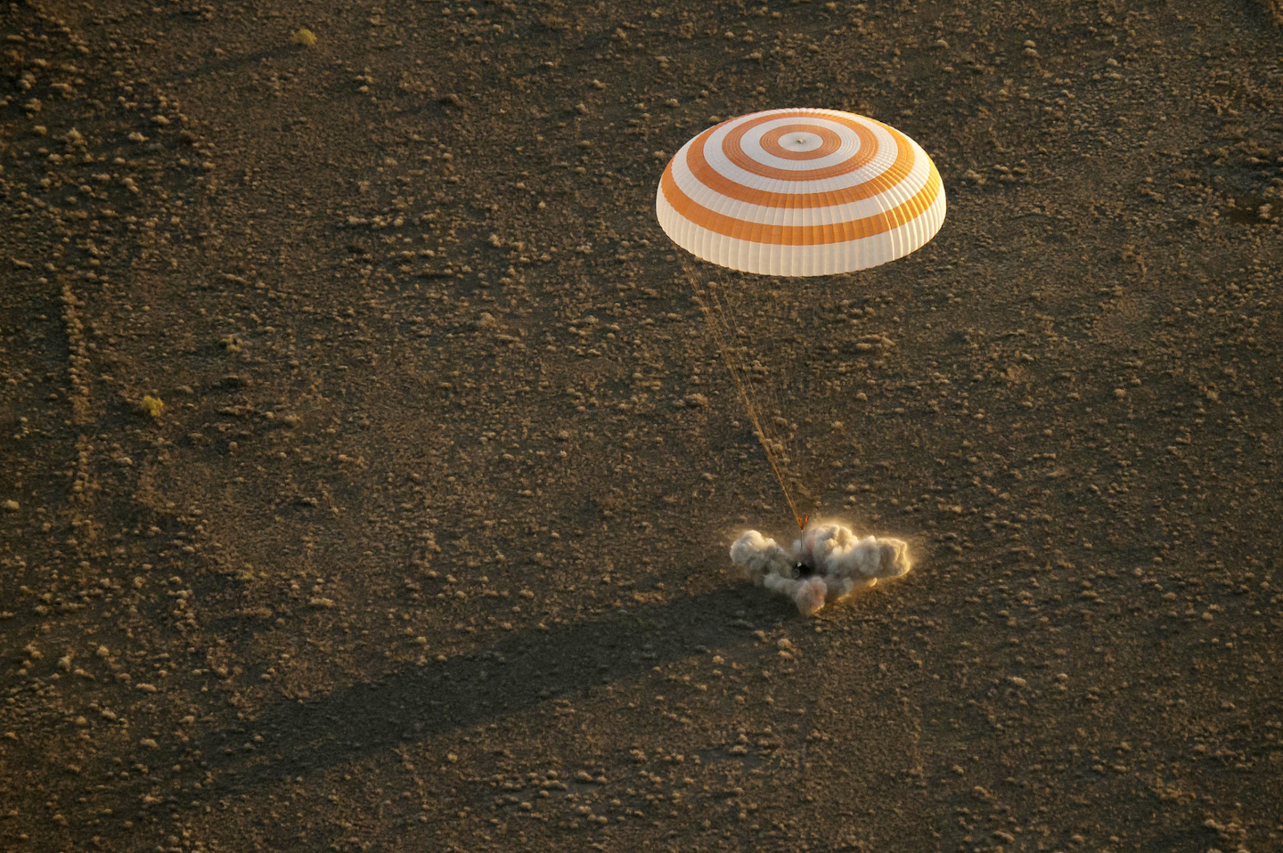 A record-setting American and two Russians landed safely back on Earth Wednesday after a six-month mission aboard the International Space Station. (Bill Ingalls/NASA via AP)