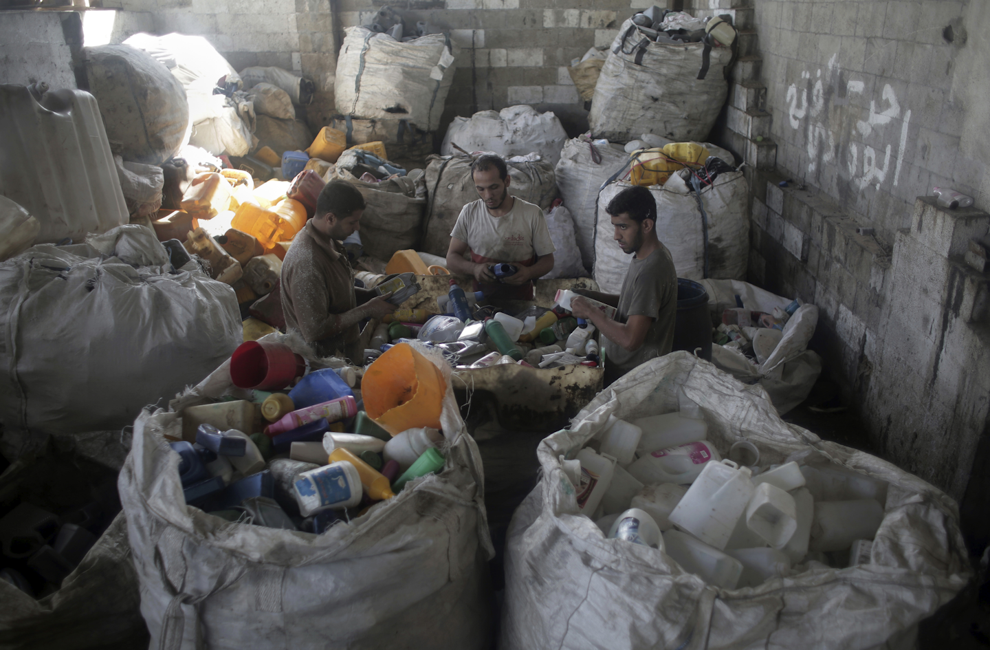 In this Tuesday, Oct. 18, 2016 photo, Palestinian workers sort the plastic bottles before the recycling process in a plastic factory in Gaza City. In the struggling Gaza Strip, Omar Ramlawi’s plastic factory is one of the few businesses that has managed to stay afloat, overcoming dire shortages of raw materials by resorting to an unusual source: recycling. Recycling has never been a priority in Gaza, a crowded and impoverished seaside territory whose already weak economy has been devastated by years of conflict with Israel and mismanagement by the ruling Islamic militant Hamas movement. (AP Photo/ Khalil Hamra)