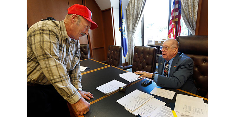 Farmer Tom Marsoton, of Pittsfield, N.H., left, talks with Republican Rep. Bob Haefner, of Hudson, chairman of the Milk Producers Emergency Relief Fund Board, Monday, Oct. 3, 2016, in Concord, N.H. The board is trying to see what can be done quickly as farmers struggle with low milk prices and drought conditions. Nineteen of the state's 120 dairies have closed in recent months. (AP Photo/Jim Cole)