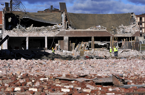 In this Nov. 24, 2012 file photo, inspectors assess damage around the area of a gas explosion that leveled a strip club in Springfield, Mass., on Nov. 23. New or replaced gas service lines for apartments and small businesses across the United States must be equipped with inexpensive safety valves starting next year following deadly fires and explosions over decades that could have been avoided, the Obama administration announced Tuesday, Oct. 11, 2016. (AP Photo/Jessica Hill, File)
