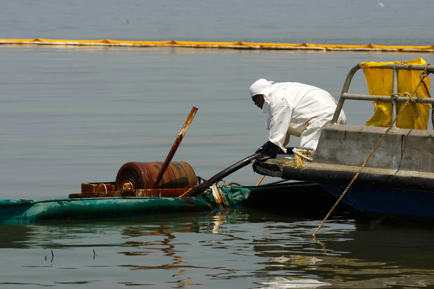 A contractor operates an oil skimmer near a marsh impacted from the Deepwater Horizon oil spill in Pass a Loutre, La. (AP Photo/Gerald Herbert, File)