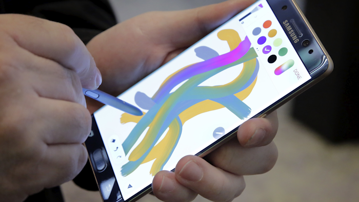An overheated Samsung device created smoke that caused a plane to be evacuated at Louisville International Airport on Wednesday, Oct. 5, 2016 an official said. (AP Photo/Richard Drew, File)