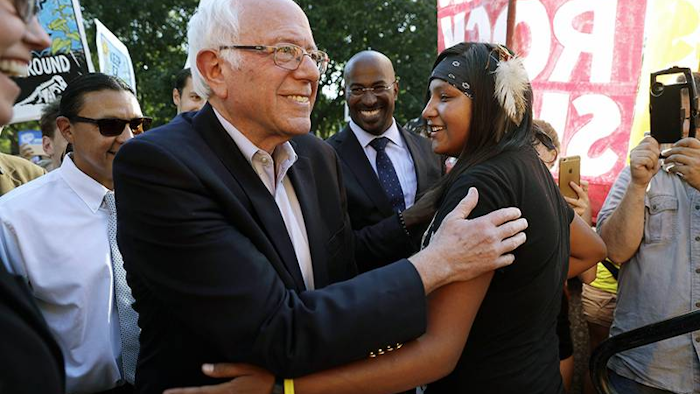 Sen. Bernie Sanders, I-Vt., left, greets Jasilyn Charger, a member of the Cheyenne River Sioux Tribal Youth Council, after Charger spoke to a group of supporters of the Standing Rock Sioux Tribe who were rallying in opposition of the Dakota Access oil pipeline. (AP Photo/Jacquelyn Martin)