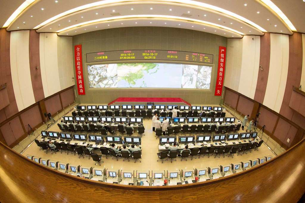 Taken with a fisheye lens, technicians monitor from the Beijing Aerospace Control Center in Beijing ahead of the planned Shenzhou 11 manned spacecraft to be launched from northern China, Monday, Oct. 17, 2016. (Ju Zhenhua/Xinhua via AP)