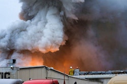 Los Angeles County firefighters watch as an explosions erupts from a commercial fire at a warehouse in Maywood, Calif. (AP Photo/Richard Vogel,File)