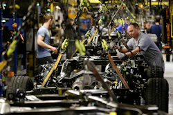 A worker prepares a chassis to receive an engine on a new aluminum-alloy body Ford F-150 truck at the company's Kansas City Assembly Plant in Claycomo, Mo. (AP Photo/Charlie Riedel)