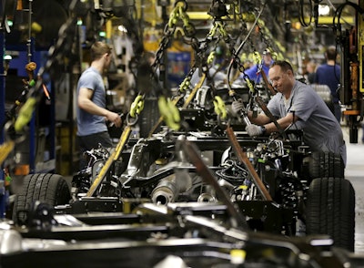 A worker prepares a chassis to receive an engine on a new aluminum-alloy body Ford F-150 truck at the company's Kansas City Assembly Plant in Claycomo, Mo. (AP Photo/Charlie Riedel)