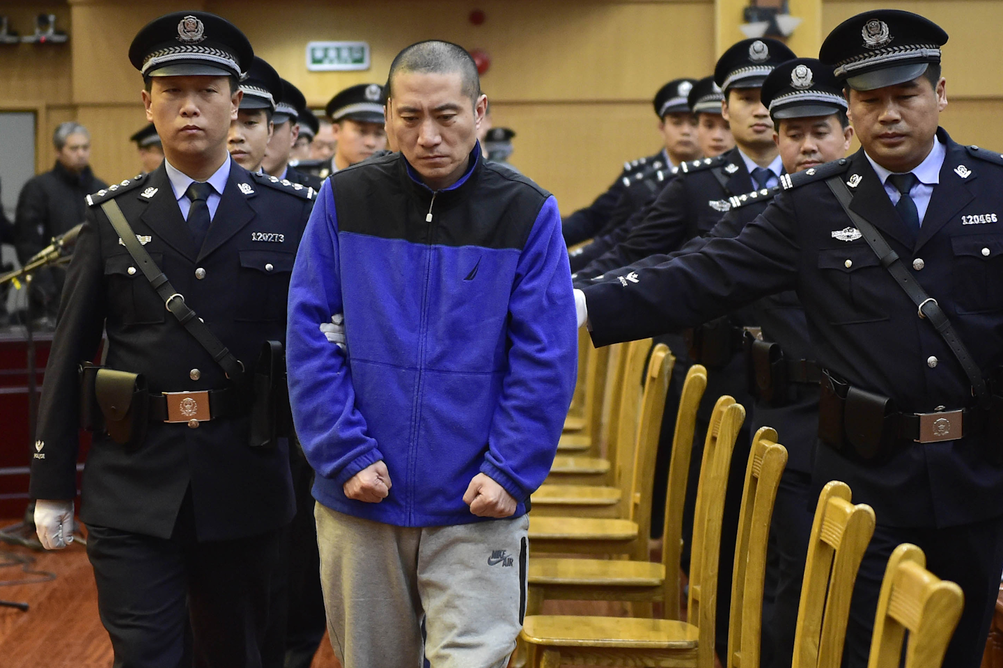 n this photo released by Xinhua News Agency, Ruihai International Logistics Chairman Yu Xuewei, center, is led by police officers as he arrives for his trial at the Tianjin's No. 2 Intermediate Court in north China's Tianjin Municipality, Wednesday, Nov. 9, 2016. A Chinese court on Wednesday gave the head of a logistics company a suspended death sentence over a massive explosion at a chemical warehouse in Tianjin last year that killed 173 people, most of them firefighters and police officers. (Yue Yuewei/Xinhua via AP)