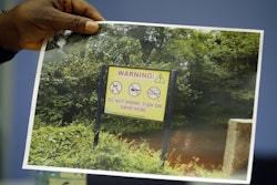 The King of Ogale, King Okpab, shows a picture taken near the Ogale area in Nigeria as he speaks during an interview with The Associated Press in London, Monday, Nov. 21, 2016. Britain’s High Court will begin hearing lawsuits on Tuesday filed by the Ogale and Bille people alleging that decades of oil spills have fouled the water and destroyed the lives of thousands of fishermen and farmers in the Niger River Delta. (AP Photo/Frank Augstein)