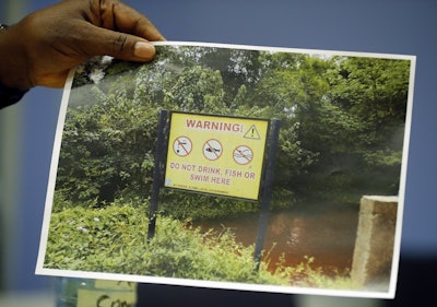 The King of Ogale, King Okpab, shows a picture taken near the Ogale area in Nigeria as he speaks during an interview with The Associated Press in London, Monday, Nov. 21, 2016. Britain’s High Court will begin hearing lawsuits on Tuesday filed by the Ogale and Bille people alleging that decades of oil spills have fouled the water and destroyed the lives of thousands of fishermen and farmers in the Niger River Delta. (AP Photo/Frank Augstein)