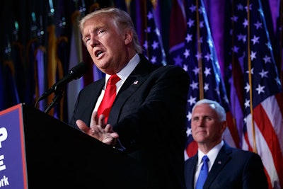 Vice president-elect Mike Pence, right, watches as President-elect Donald Trump speaks during an election night rally, Wednesday, Nov. 9, 2016, in New York. (AP Photo/ Evan Vucci)