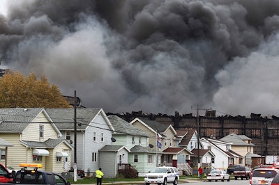 Smoke rises from a fire at a former Bethlehem Steel site, Wednesday, Nov. 9, 2016, in Lackawanna, N.Y. The blaze broke out when a hot light bulb fell onto cardboard inside a business, authorities said. (AP Photo/Jeffrey T. Barnes)