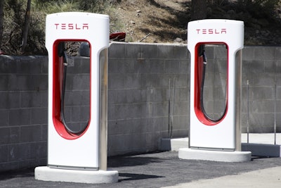 This undated file photo shows Tesla Motors charging stations neat Truckee, Calif. Electric car maker Tesla Motors says it will end unlimited free use of its worldwide charging station network. The company says cars ordered after Jan. 1, 2017 will get roughly 1,000 miles worth of credits at the supercharging stations. After credits are used, owners will have to pay fees. Cars ordered or sold on or before Jan. 1 would still get free charging. (Margaret Moran/Sierra Sun via AP, File)
