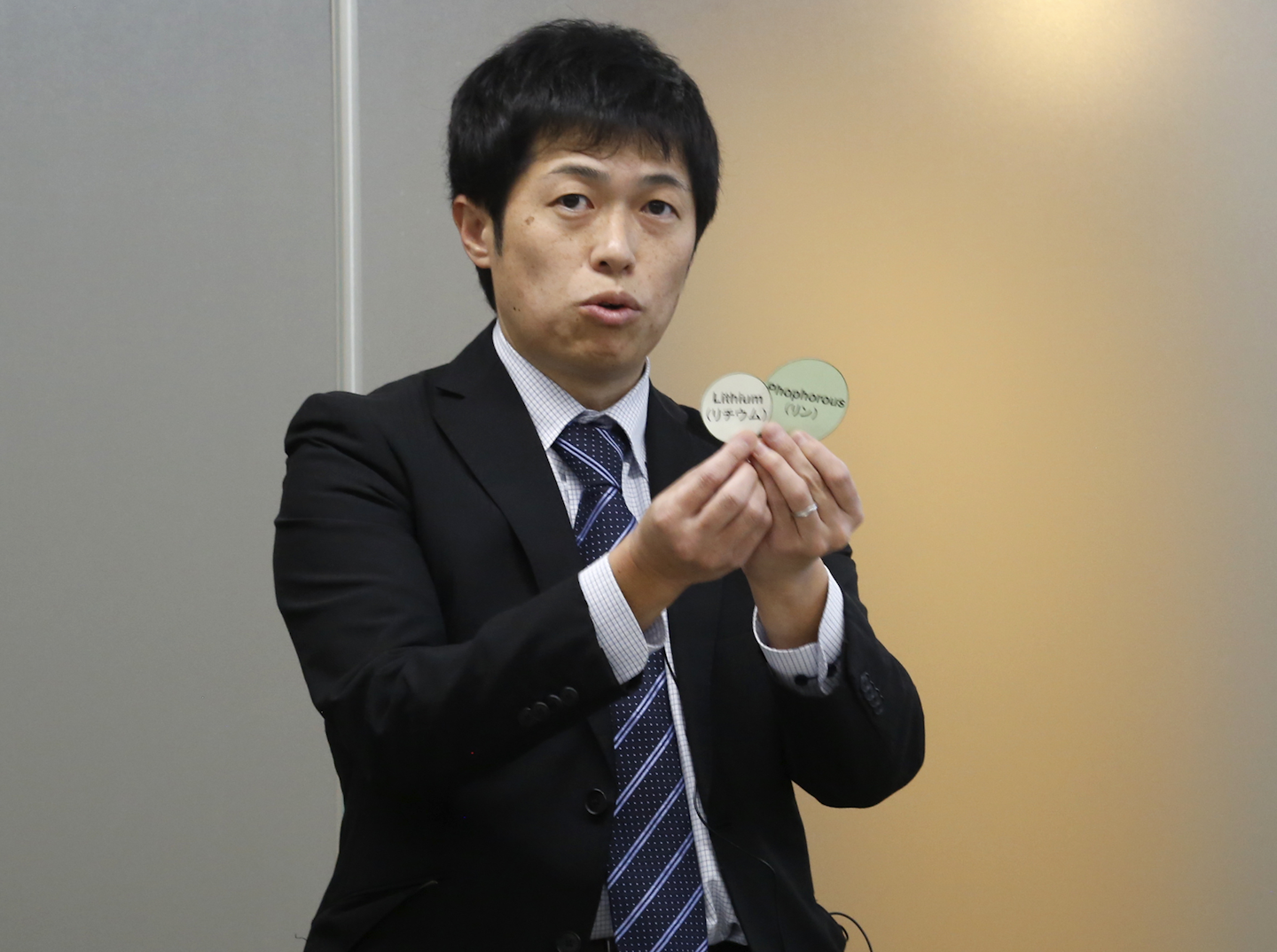 Toyota Motor Corp. engineer Hisao Yamashige speaks to reporters at the Japanese automaker's Tokyo office Thursday, Nov. 24, 2016. Toyota says it has developed a new way of observing the movements of tiny particles in a battery used to power electric vehicles — an advance it says will help boost their cruise range by 10 percent to 15 percent. Yamashige explained to reporters the complex method for tracking the lithium ions, which are tiny particles in lithium-ion batteries, also used in laptops and smartphones. (AP Photo/Yuri Kageyama)
