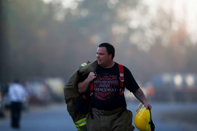 An Alabaster firefighter walks near the scene of an explosion of a Colonial Pipeline, Monday, Oct. 31, 2016, in Helena, Ala. (AP Photo/Brynn Anderson)