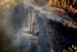 A flame continues to burn after a Monday explosion of a Colonial Pipeline, Tuesday, Nov. 1, 2016, in Helena, Ala. The blast, which sent flames and thick black smoke soaring over the forest, happened about a mile west of where the pipeline ruptured in September, Gov. Robert Bentley said in a statement. (AP Photo/Brynn Anderson)