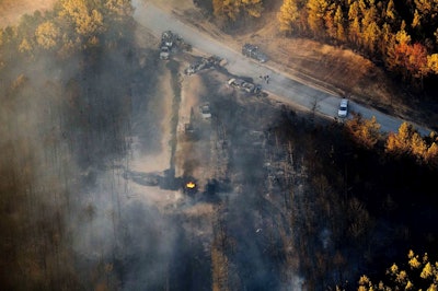 A flame continues to burn after a Monday explosion of a Colonial Pipeline, Tuesday, Nov. 1, 2016, in Helena, Ala. The blast, which sent flames and thick black smoke soaring over the forest, happened about a mile west of where the pipeline ruptured in September, Gov. Robert Bentley said in a statement. (AP Photo/Brynn Anderson)
