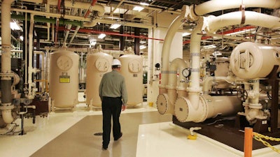 An Exelon employee walks past equipment in the turbine building at the Oyster Creek nuclear plant in Lacey Township, N.J. Called 'Oyster Creak' by some critics because of its aging problems, this boiling water reactor began running in 1969 and ranks as the country's oldest operating commercial nuclear power plant. (AP Photo/Mel Evans)