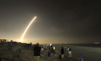 Cell phones light up the beaches of Cape Canaveral and Cocoa Beach, Fla., north of the Cocoa Beach Pier as spectators watch the launch of the NOAA GOES-R weather satellite, Saturday, Nov. 19, 2016. (Malcolm Denemark/Florida Today via AP)