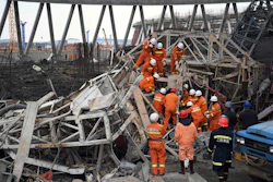 Rescue workers look for survivors after a work platform collapsed at the Fengcheng power plant in eastern China's Jiangxi Province. (Wan Xiang/Xinhua via AP, File)