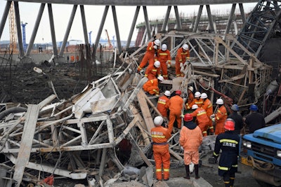 Rescue workers look for survivors after a work platform collapsed at the Fengcheng power plant in eastern China's Jiangxi Province. (Wan Xiang/Xinhua via AP, File)