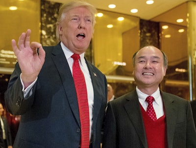 In this Tuesday, Dec. 6, 2016, file photo, President-elect Donald Trump, left, accompanied by SoftBank CEO Masayoshi Son, speaks to members of the media at Trump Tower in New York. Trump gave himself kudos for the creation of 8,000 new U.S. jobs by Japanese tech mogul Son, saying it was proof of 'the spirit and the hope' stirred by his presidential win. But for those particular jobs, Trump was basically taking a bow for the second time. (AP Photo/Andrew Harnik, File)