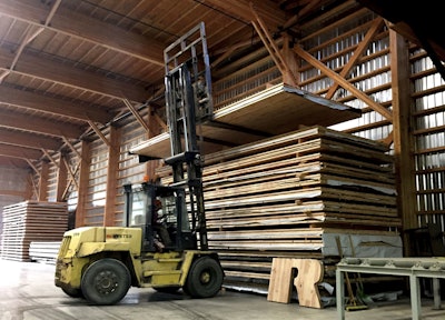 In this Nov. 11, 2016 photo, a forklift driver moves a newly assembled panel of cross-laminated timber, or CLT, to a stack in the production facility of D.R. Johnson Lumber Co., in Riddle, Ore. D.R. Johnson is one of just two companies in the United States currently able to produce CLT panels. (AP Photo/Gillian Flaccus)