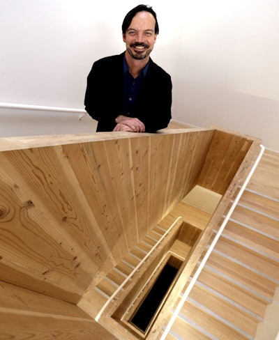 In this Nov. 15, 2016, photo, Lever Architecture founder Thomas Robinson poses for a photo in his company's all-wood headquarters building, built with cross-laminated timber, or CLT, in Portland, Ore. Lever Architecture is about to break ground on a 12-story all-wood building, using CLT, in Portland's Pearl District that the company says will be the tallest all-wood building in the world in a seismic zone and the tallest all-wood building in North America. (AP Photo/Don Ryan)