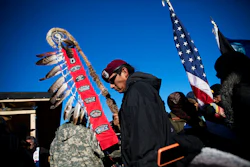 Native American veterans join an interfaith ceremony at the Oceti Sakowin camp where people have gathered to protest the Dakota Access oil pipeline in Cannon Ball, N.D., Sunday, Dec. 4, 2016. Tribal elders have asked the military veterans joining the large Dakota Access pipeline protest encampment not to have confrontations with law enforcement officials, an organizer with Veterans Stand for Standing Rock said Sunday, adding the group is there to help out those who've dug in against the four-state, $3.8 billion project. (AP Photo/David Goldman)