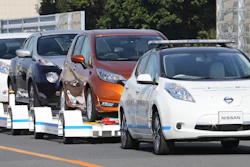 Nissan Motor Co. is testing out self-driving cars at one of its plants in Japan to tow vehicles on a trailer to the wharf for loading without anyone behind the steering wheel. (AP Photo/Koji Sasahara)
