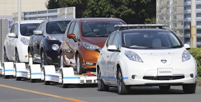 Nissan Motor Co. is testing out self-driving cars at one of its plants in Japan to tow vehicles on a trailer to the wharf for loading without anyone behind the steering wheel. (AP Photo/Koji Sasahara)